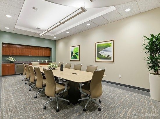 Private office conference room with a large meeting table and chairs